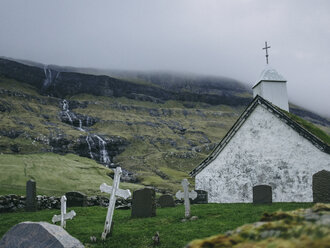 Church by mountains against cloudy sky - CAVF23575