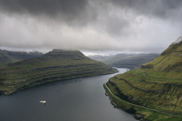 Idyllic view of mountains by sea against stormy clouds - CAVF23585