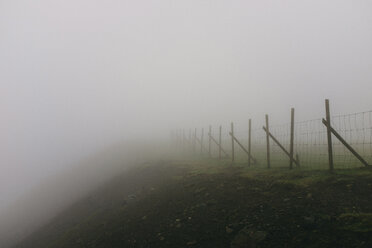 Fence on mountain during foggy weather - CAVF23593