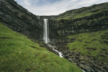 Scenic view of waterfall against cloudy sky - CAVF23621