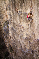 Side view of woman climbing mountain - CAVF23874