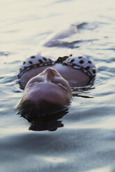 Close-up of seductive woman in lake - CAVF24040