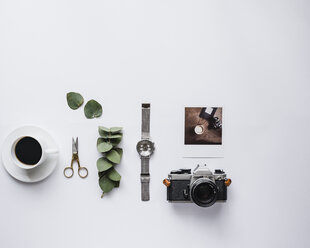 Overhead view of black coffee with accessories against white background - CAVF24320