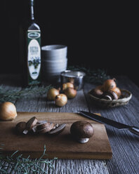 Button mushrooms with onion and knife on cutting board - CAVF24336