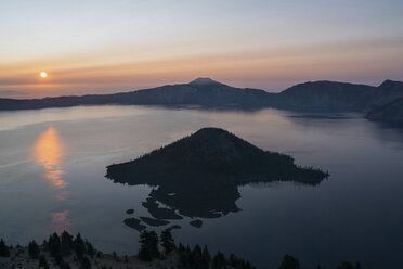 Scenic view of Crater Lake National Park against sky during sunset - CAVF24479