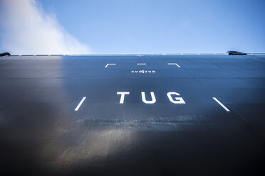 Low angle view of tug text on ship against sky - CAVF24517