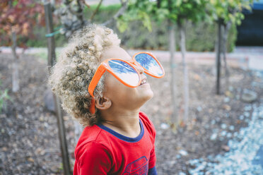 Playful boy in sunglasses looking up - CAVF24672