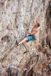 Thailand, Krabi, Lao Liang, barechested climber in rock wall - ALRF01016