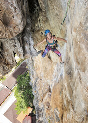 Thailand, Krabi, Tonsai beach, woman climbing in rock wall - ALRF01031