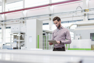 Geschäftsmann mit Tablet in der Produktionshalle - DIGF03482