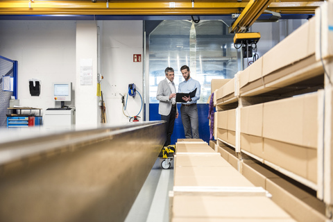 Businessmen during meeting with clipboard in storage stock photo