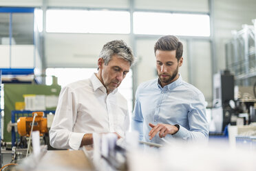 Businessmen during meeting with tablet in production hall - DIGF03516