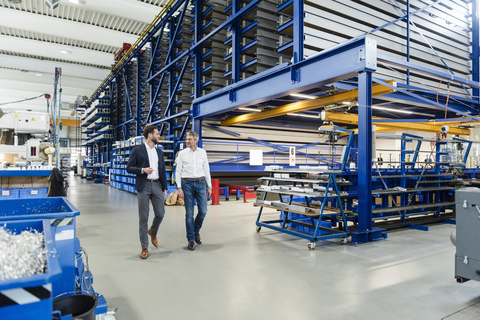 Businessmen during meeting in production hall stock photo