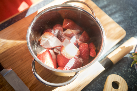 Making strawberry jam in cooking pot stock photo