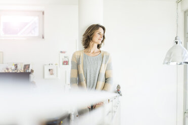 Woman leaning against a column at home - MOEF00959