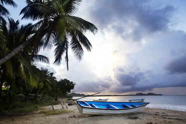 Boat moored on sea shore at beach against cloudy sky - CAVF25008
