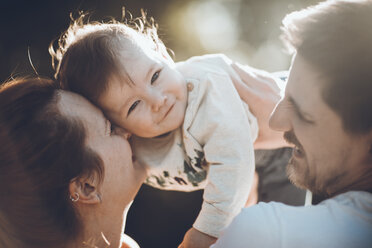 Close-up of happy parents playing with son at park - CAVF25077