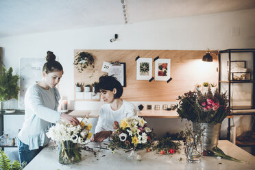 Florists arranging flowers at store - CAVF25104