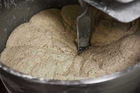 Close-up of machinery kneading dough in bakery - CAVF25184