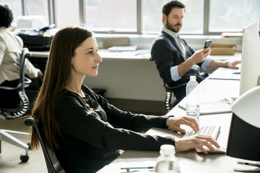 Business people working at desk in office - CAVF25223