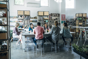 Business people having discussion during meeting while sitting at conference table - CAVF25276