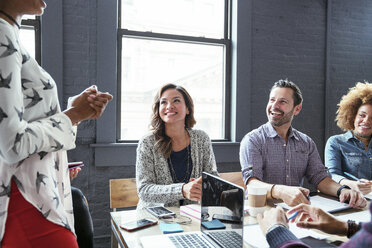 Midsection of businesswoman explaining colleagues in meeting room - CAVF25585