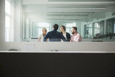 Geschäftsleute, die im Büro diskutieren, gesehen durch ein Fenster - CAVF26041