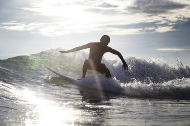 Boy surfing on sea during summer vacation - CAVF26698