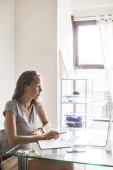 Woman working on laptop at home - CAVF26746