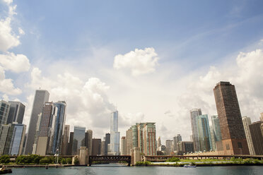 Low angle view of skyscrapers against cloudy sky - CAVF26871