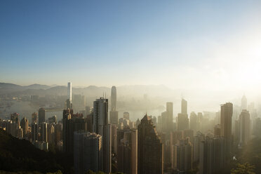 High angle view of modern cityscape in foggy weather at dusk - CAVF26872