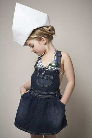 Fashionable little girl wearing big paper hat stock photo