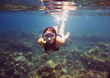 Portrait of young woman snorkeling in sea - CAVF27092