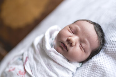 Close-up of baby girl wrapped in blanket - CAVF27170