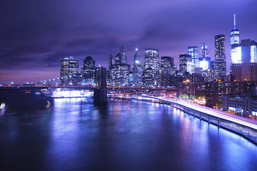 Brooklyn Bridge over river against illuminated city - CAVF27211