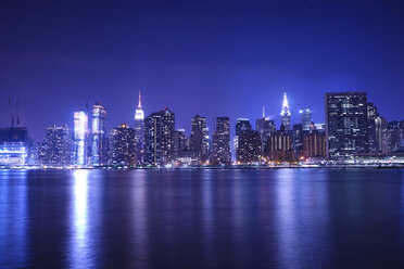 River against illuminated cityscape at night - CAVF27212