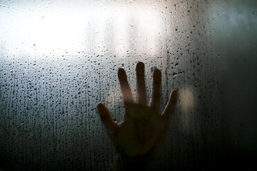 Close-up of hand on wet glass - CAVF27258