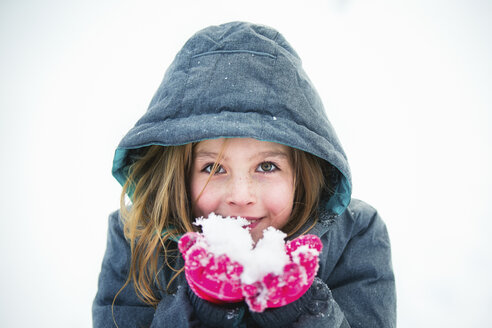 Portrait of girl holding snow - CAVF27263