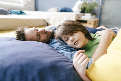 Father and son sleeping at home stock photo