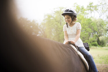 Glückliches Mädchen beim Reiten auf dem Bauernhof - CAVF27629