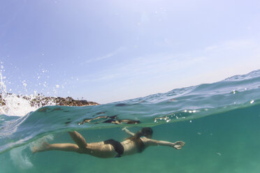 Woman swimming in sea against sky - CAVF27639