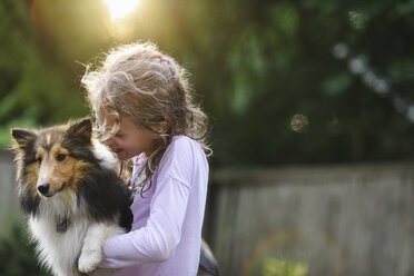 Mädchen spielt mit Hund im Park - CAVF27738