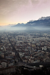 Aerial view of cityscape and mountains against sky during sunrise - CAVF27825