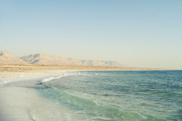 Waves rushing towards shore at beach against clear sky - CAVF28101