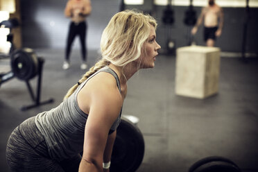 Woman in gym wearing lycra crop top and shorts stock photo