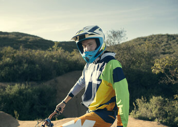 Portrait of confident biker on mountain - CAVF28248