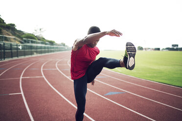 Male athlete exercising on running tracks - CAVF28266