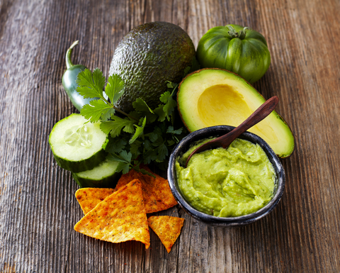Bowl of Guacamole, ingredients and tortilla chips stock photo