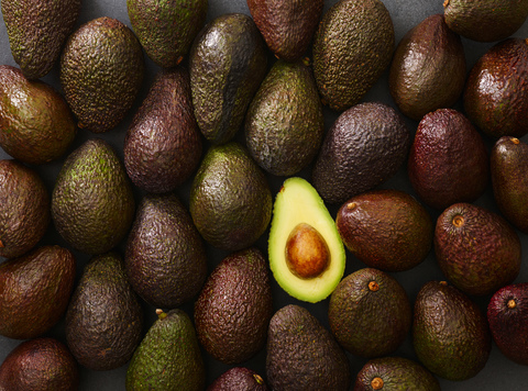 Whole and sliced avocado stock photo