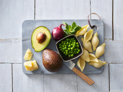 Ingredients of pasta with avocado sauce, peas and parmesan stock photo